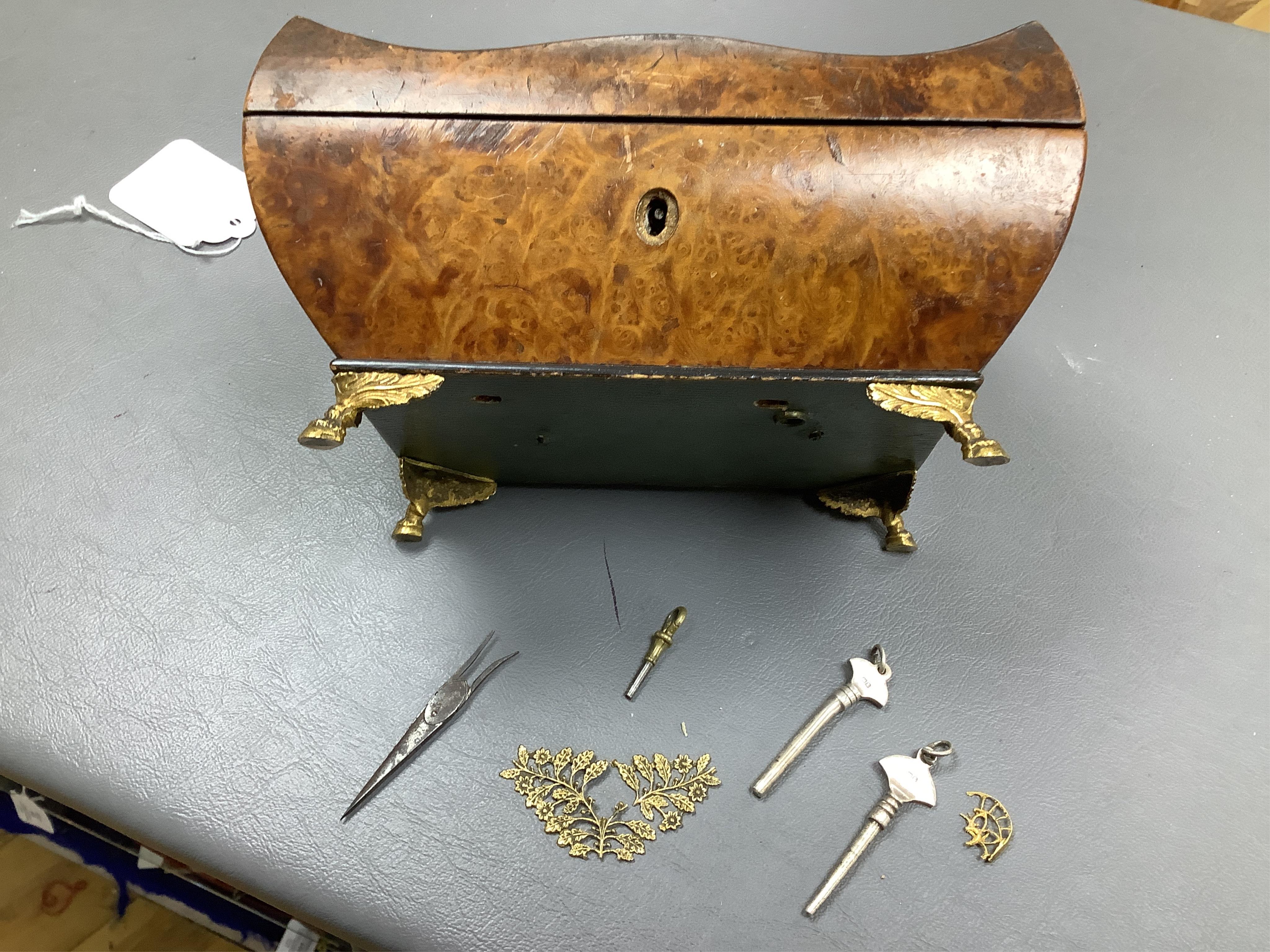 A 19th century burr walnut musical sewing box with mirrored and fitted interior and two silver keys, 18cm wide (mirror cracked)